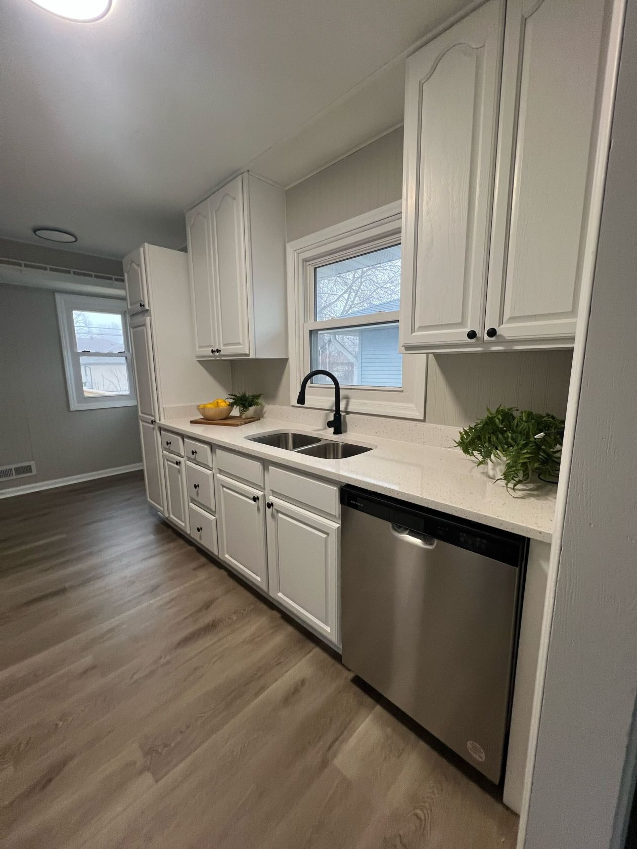 White kitchen with new dishwasher and matte black fixtures